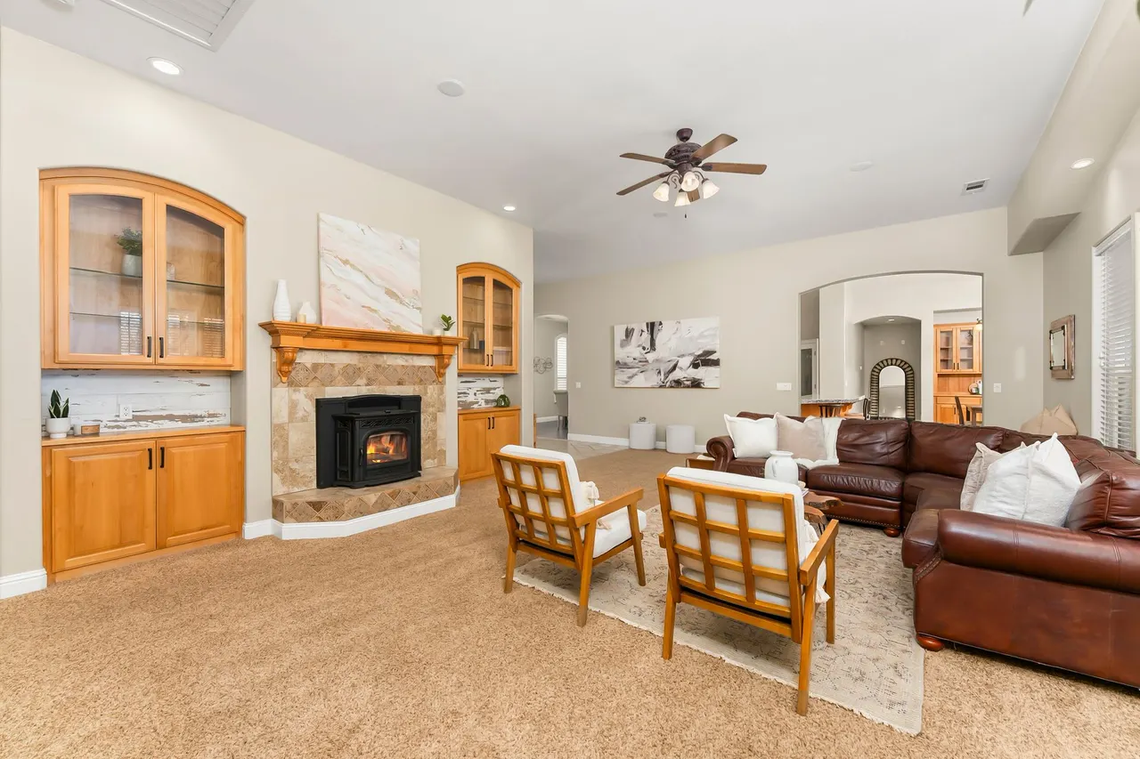 Family great room with fireplace flanked by glass-front cabinetry